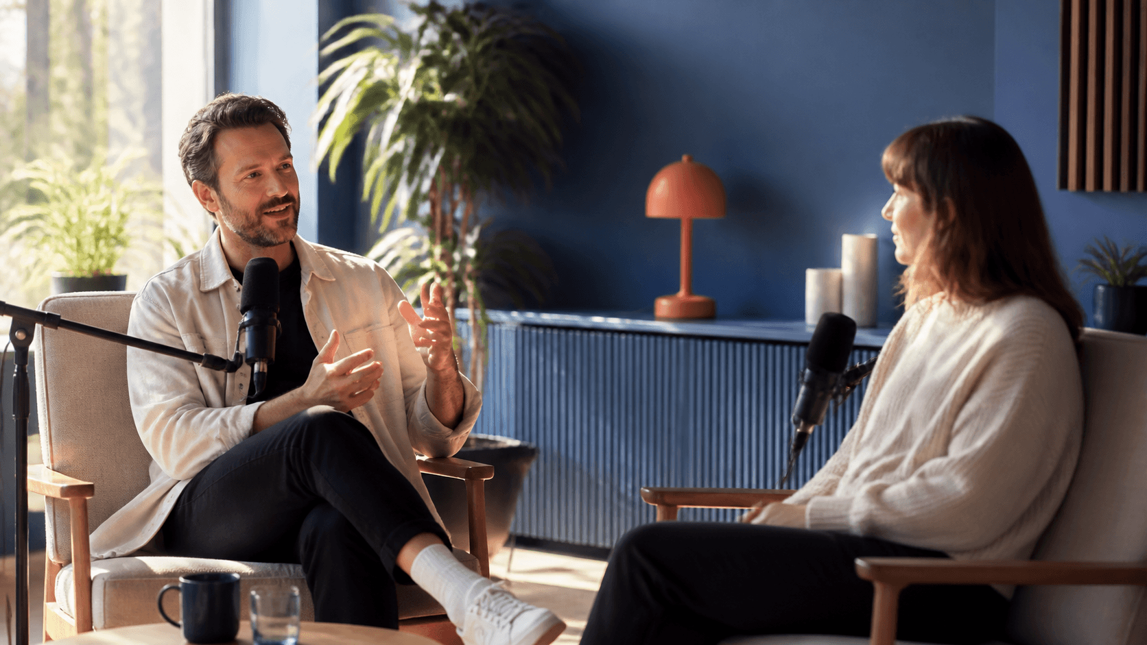 Two people recording The Creator Roundtable in a sunlit studio